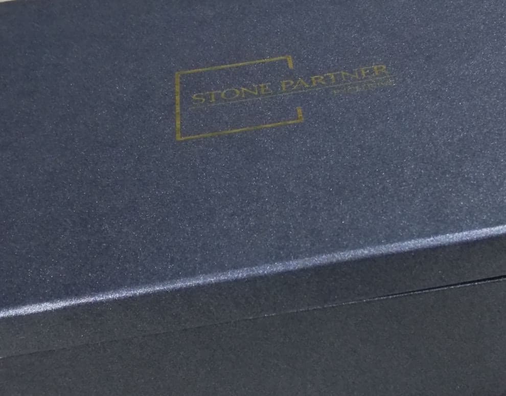 Navy rigid box with gold foil-stamped logo